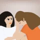 A woman with her head down, her head in her hands