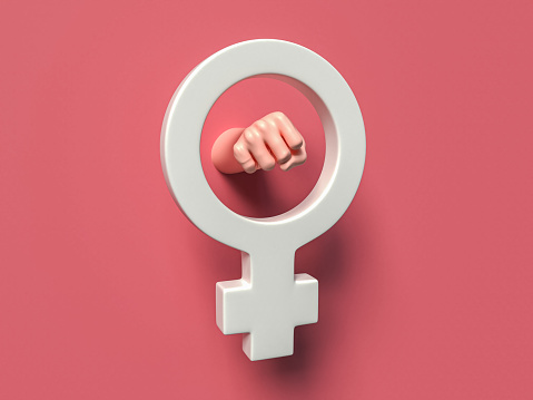 female gender symbol in white in the midlle of a pink background, a fist of a woman's hand through the circle of the symbol