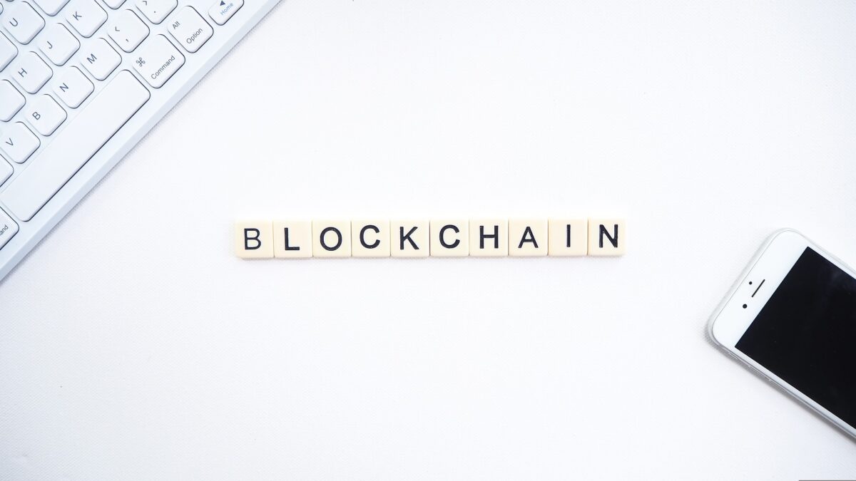 Blockchain written with Scrabble pieces on a white background