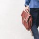 A man walking with a briefcase in his hand